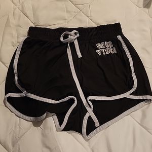An xs black pair of 'good vibes' shorts from Justify.